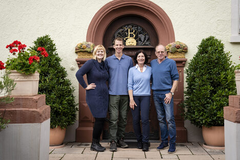 Die Familie Bernhard-Räder steht vor dem Tor des Weinguts.